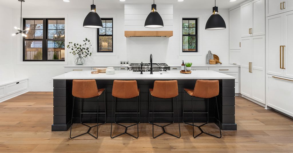 White kitchen with black island.