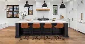 White kitchen with black island.