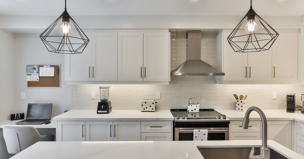 Multi-tasking kitchen with work space and statement lighting.