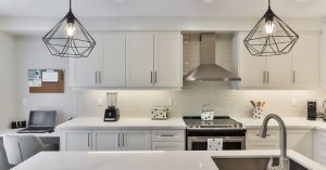 Multi-tasking kitchen with work space and statement lighting.