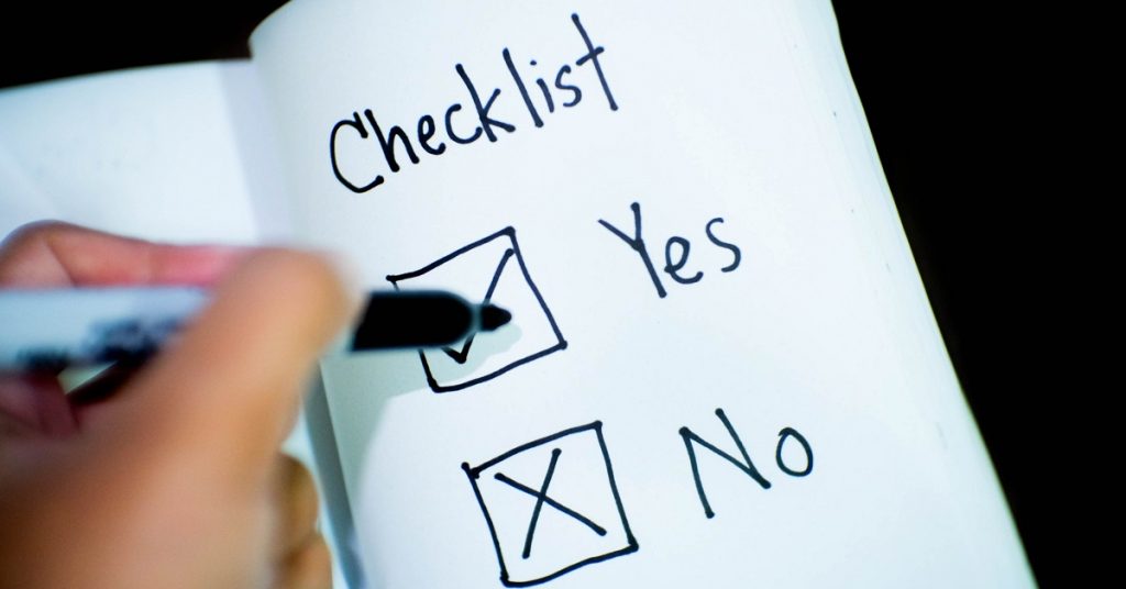 A checklist with person marking things off.