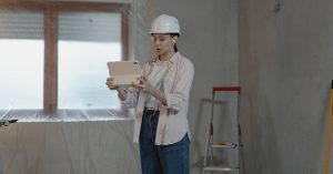 Woman planning a remodel in an empty room ready for construction.
