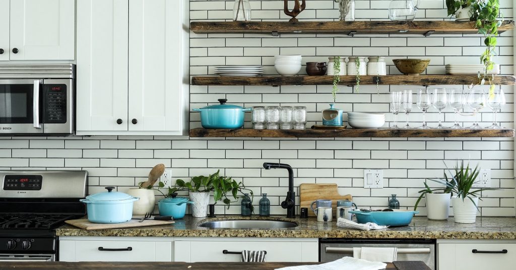 White kitchen with open shelves and vignettes.