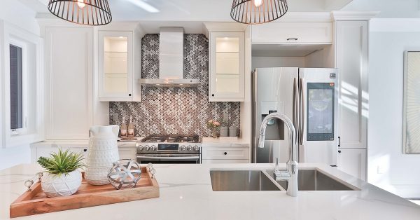 White kitchen with gray tile backsplash.