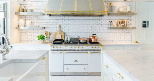 White galley kitchen with large range.