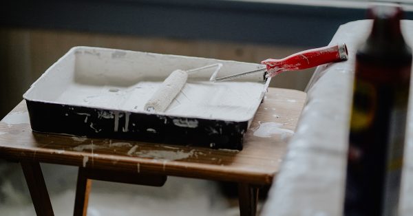 Paint roller in white paint.