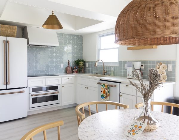 White kitchen with sage backsplash tile.