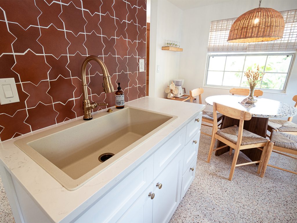 Terracotta tile on the backsplash of a kitchen with white shaker cabinets.