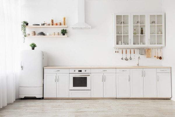 Small kitchen in white with open shelves.