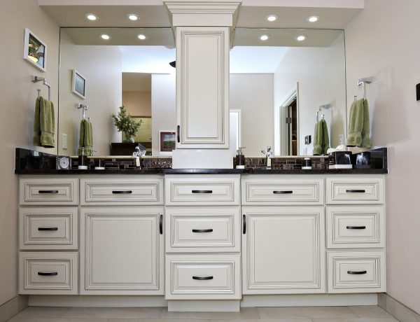 White kitchen cabinets with dark handles.