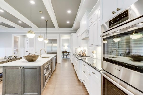 White kitchen with contrasting gray cabinets.