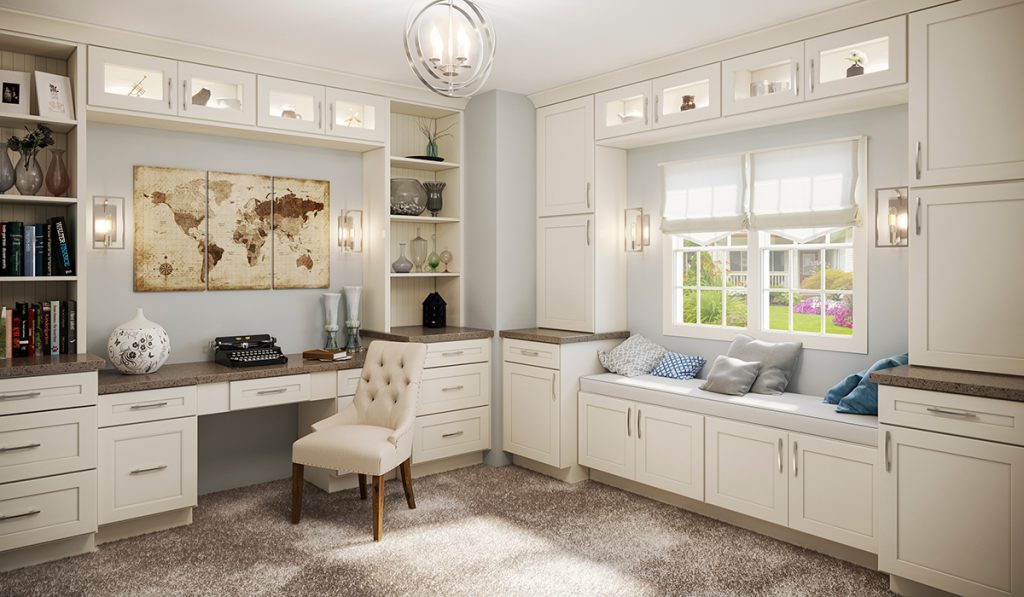 Home office with banquette under a large window.