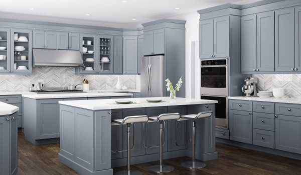 Kitchen with gray cabinets and marble backsplash in a chevron pattern.