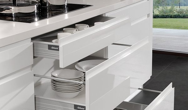 White flat front cabinets with an organized interior of plates and more.