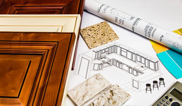 Flat lay of kitchen samples and blueprints for a new kitchen.