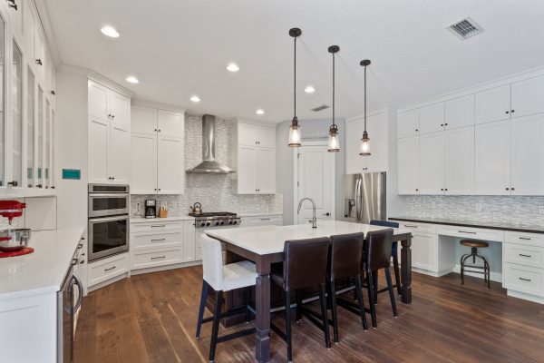 White kitchen with command center on the side.