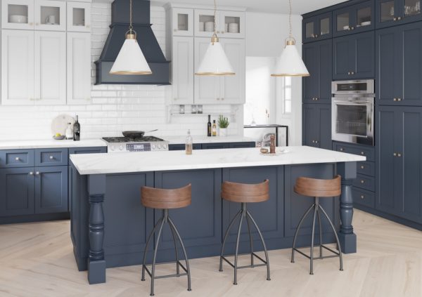 Blue and white kitchen with dark wood accents and large island.