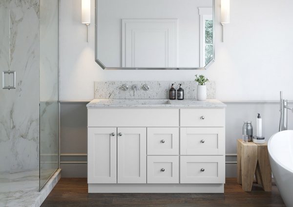 White vanity cabinets on a dark floor with large mirror and sconces on either side.
