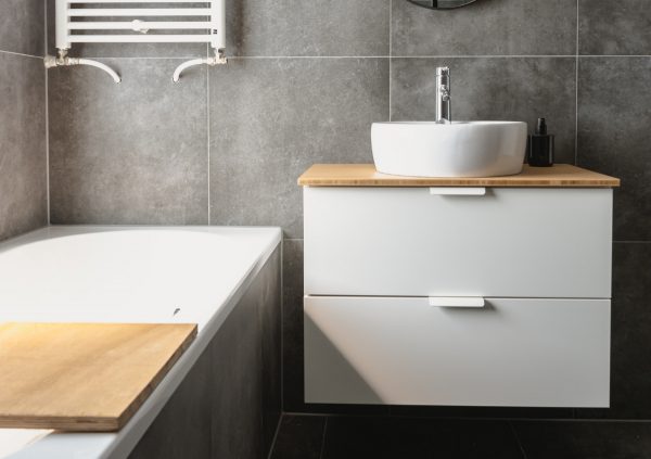 Small gray and white bathroom with flat front vanity with vessel sink.