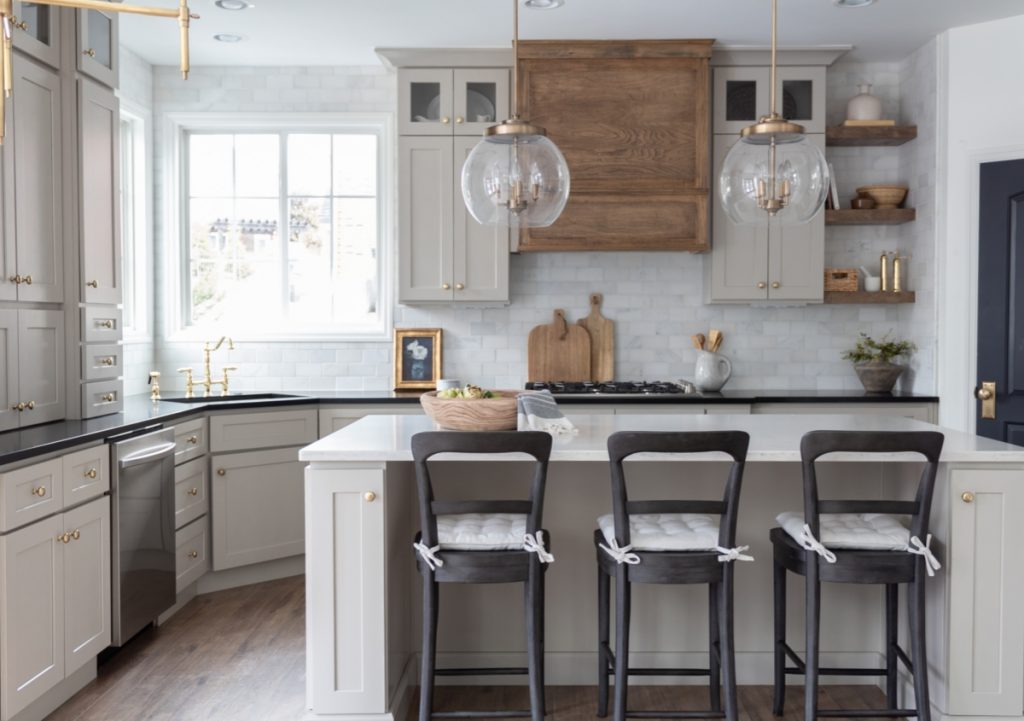 Bright kitchen with white and medium wood cabinets and dark accents.