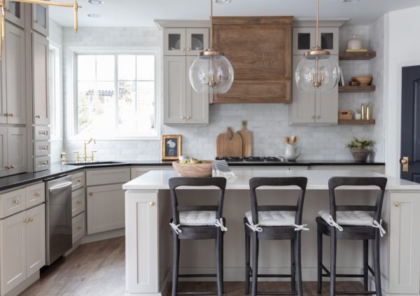 Bright kitchen with white and medium wood cabinets and dark accents.