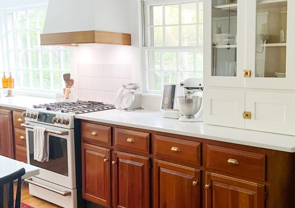 Bright kitchen with wood cabinets and white countertops.