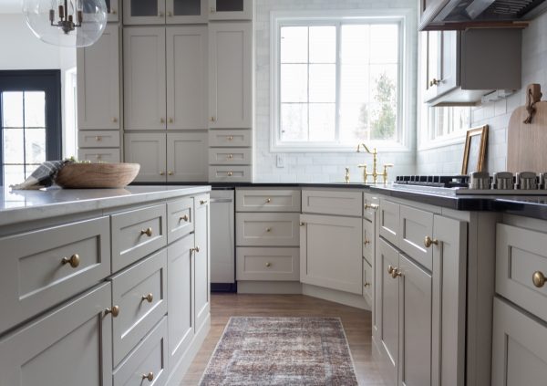 White Shaker cabinets in a cozy kitchen with big windows.