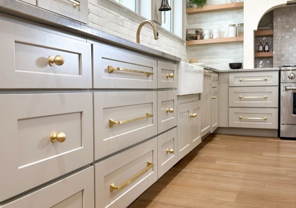 Greige cabinets in a large kitchen.
