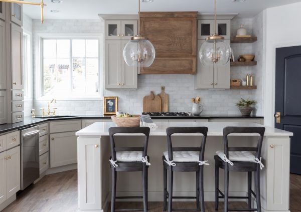 White kitchen with natural wood highlights and a large island.