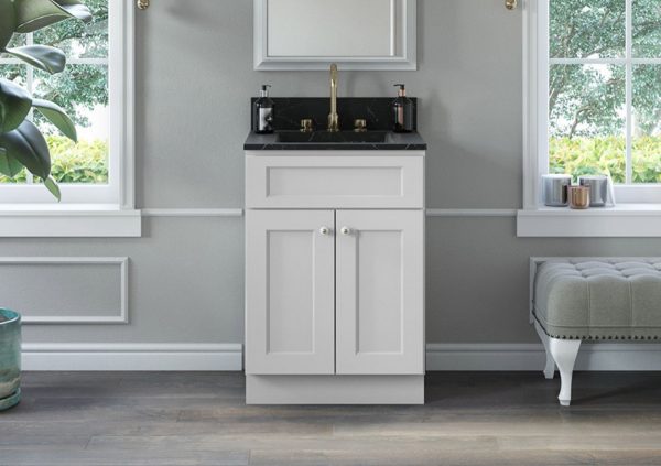 Single vanity with white cabinets and black top.