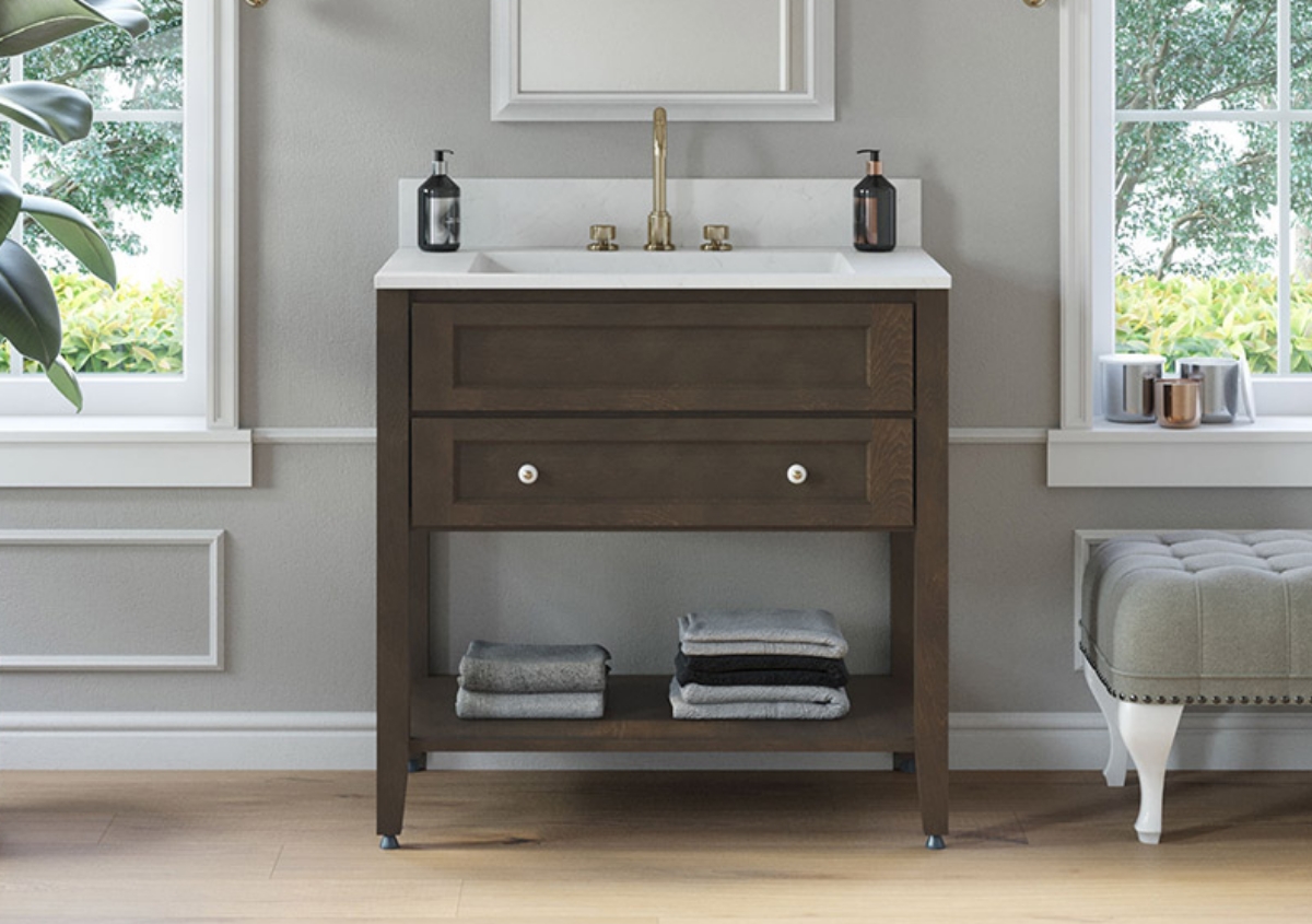 Bathroom with dark wood vanity and white top with light tile and gray walls.
