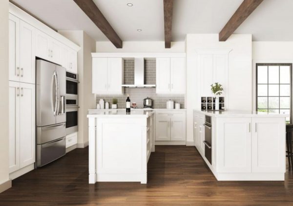 Large white kitchen with wood floors