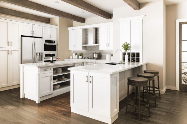 Spacious kitchen with cream cabinets and dark wood floors and ceiling beams.