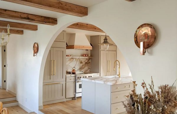 Organic modern kitchen with arched entryway.