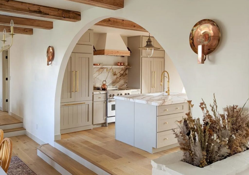 White and wood kitchen with arch.
