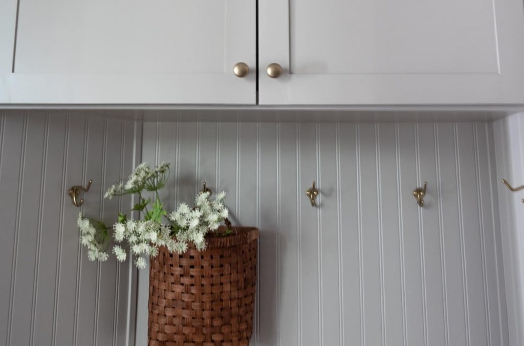 Close up of gray Shaker cabinets with round knobs on the doors.