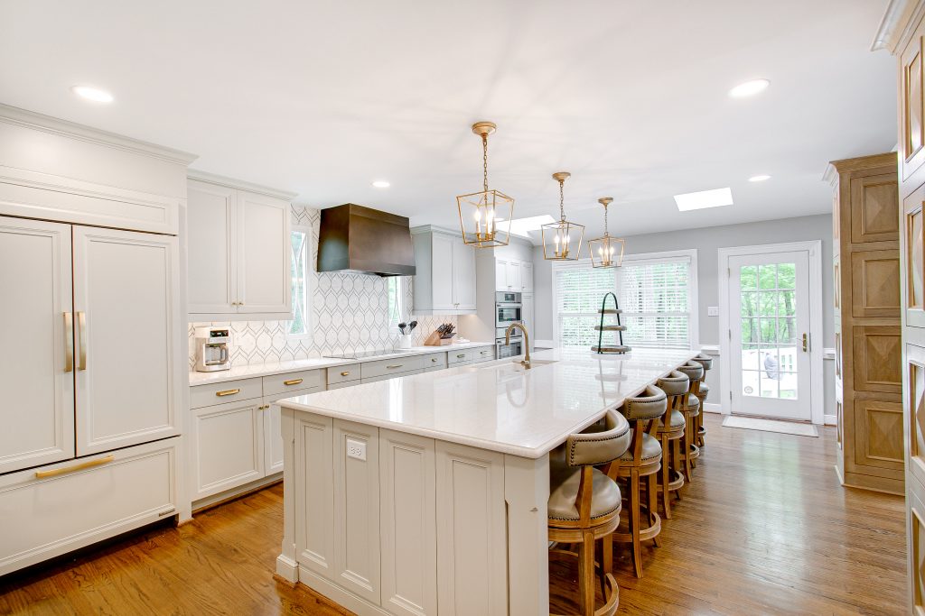 Large kitchen with cabinet panels on the refrigerator.