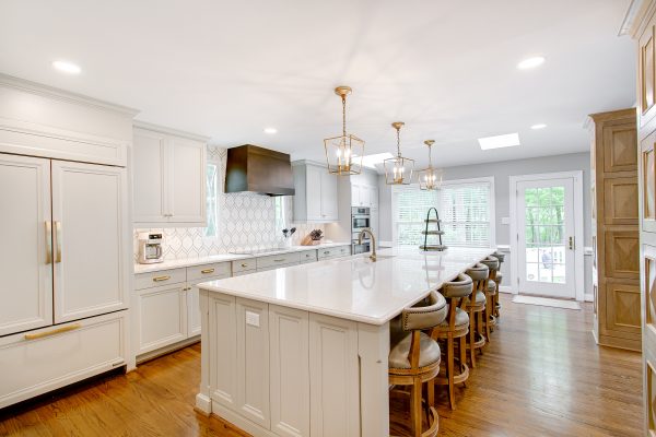 Large kitchen with cabinet panels on the refrigerator.